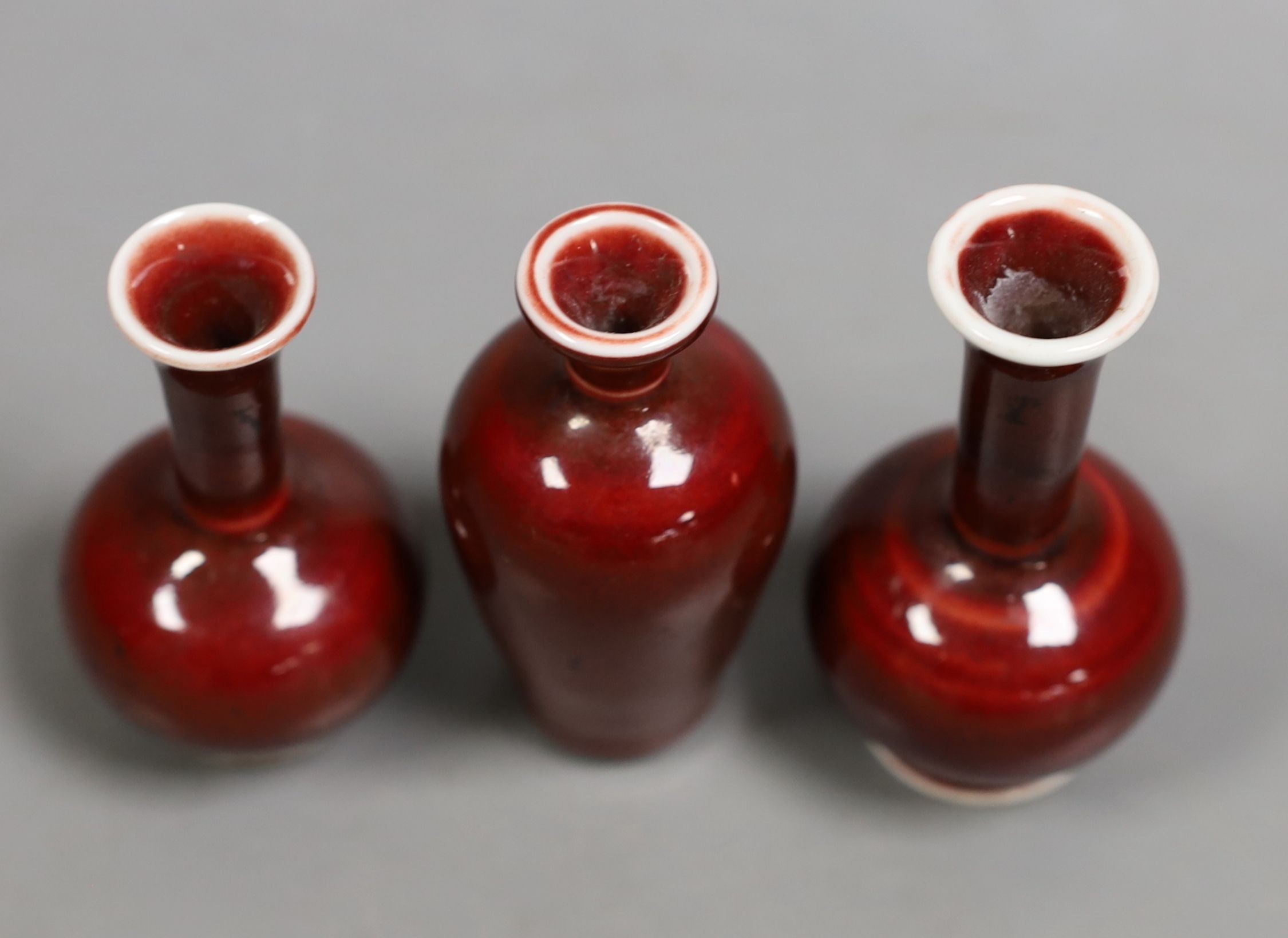 Three Chinese miniature sang-de-boeuf vases, tallest 8 cms high.